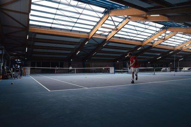 A young man playing tennis.