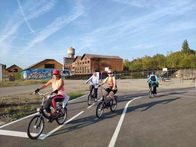 Four people on bicycles.