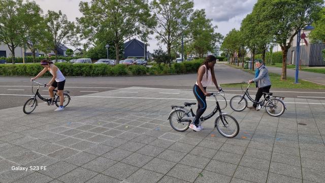 three people on bicycles.