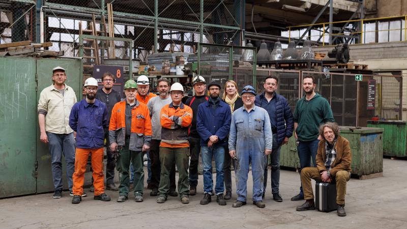 Gruppenfoto von Personen in einer industriellen Umgebung