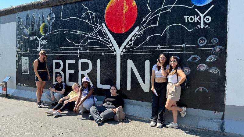 des jeunes étudiants devant un mur à Berlin